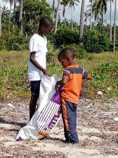 Children collecting waste in Beach cleaning day